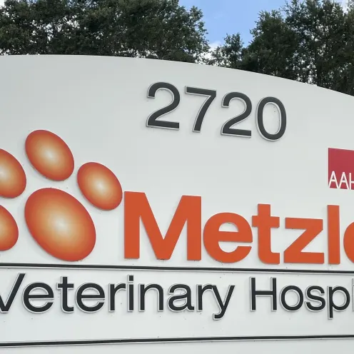 Metzler Veterinary Hospital front signage with bushes and grass