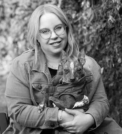 Hospital Manager Crystal posing with her dog Hospital Manager Crystal posing with her dog
