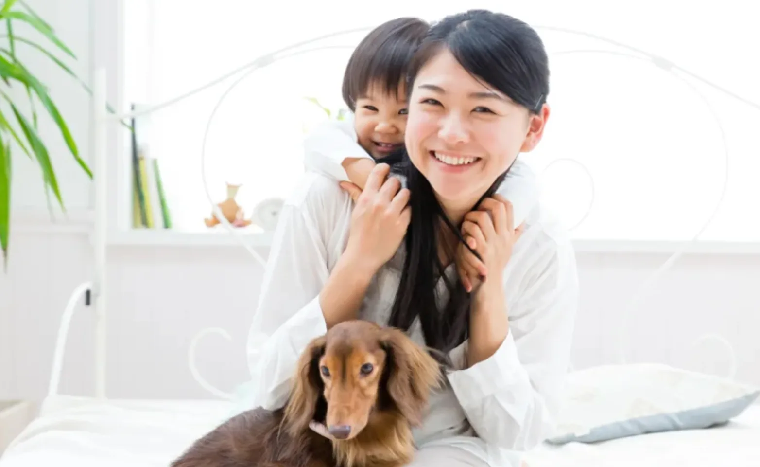 Family with Dachshund on Bed