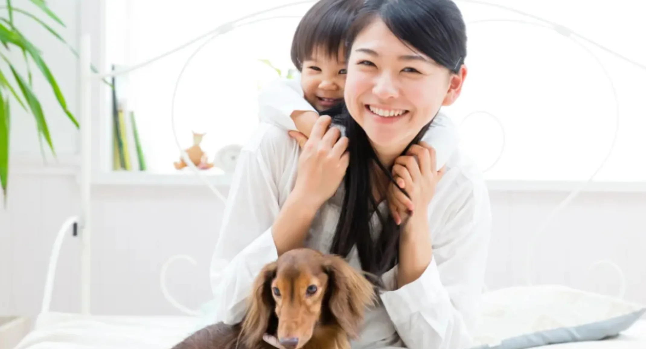 Family with Dachshund on Bed