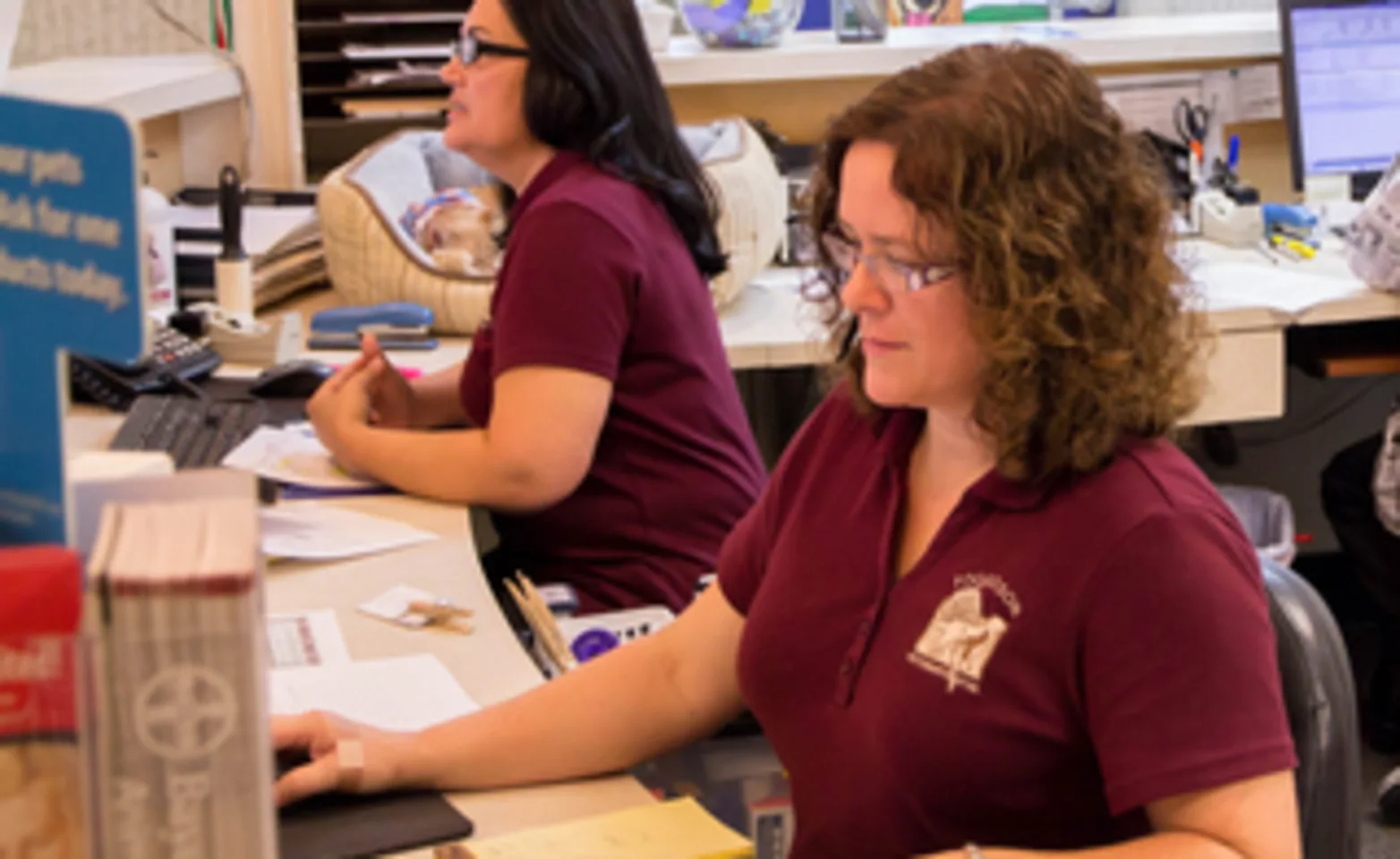 Poquoson Veterinary Hospital reception staff members sitting to check-in clients 