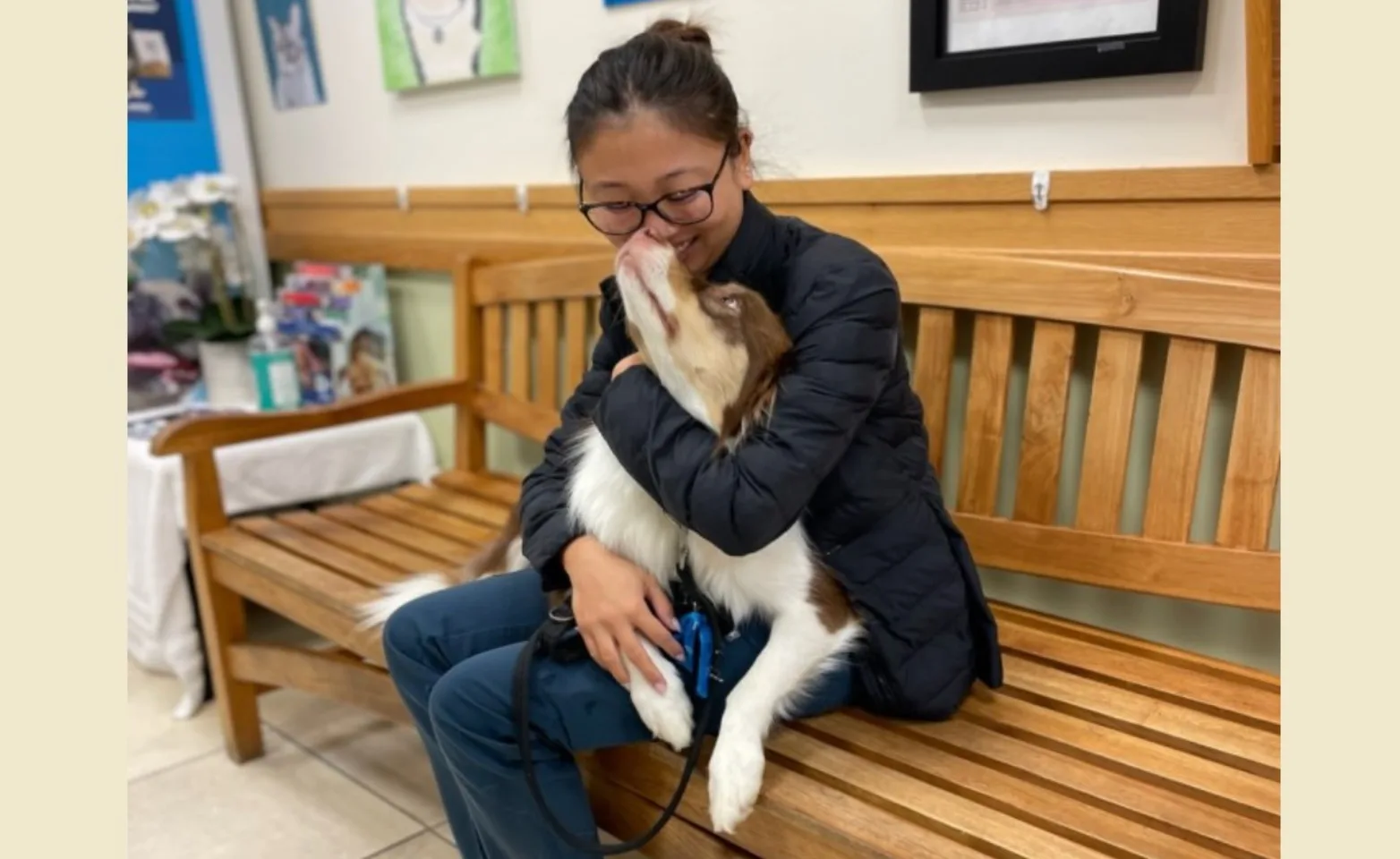 Staff member hugging dog Staff member hugging dog