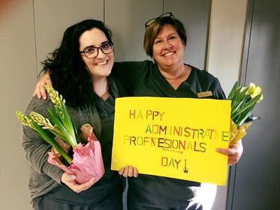 Staff posing with flowers