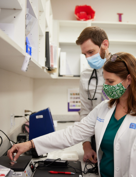 Veterinarian weighing medicine on scale