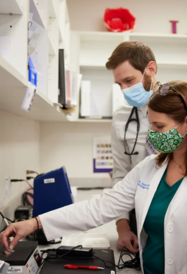 Veterinarian weighing medicine on scale Veterinarian weighing medicine on scale