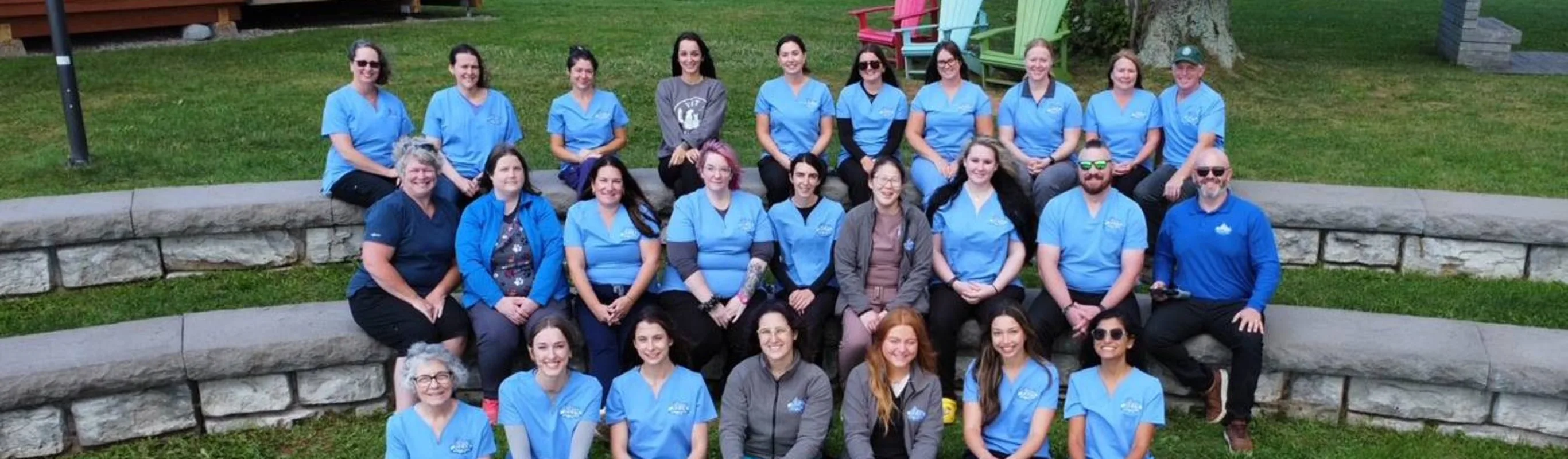 Staff sitting on grass. Staff sitting on grass.