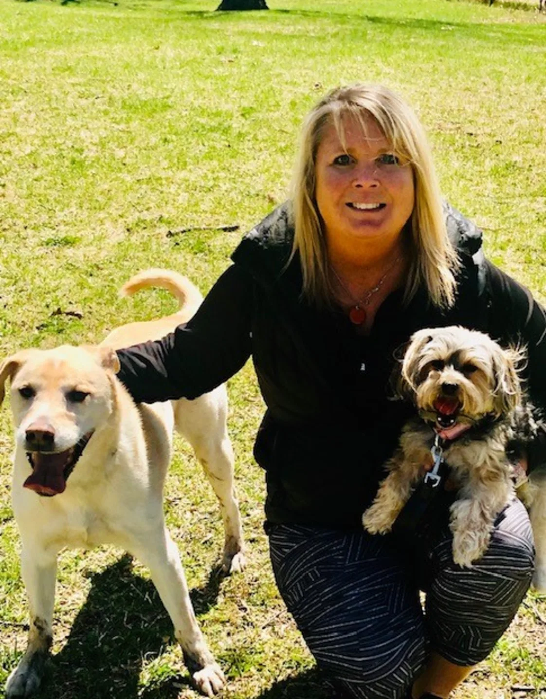 Lynn's staff photo from Stillwater Veterinary Clinic and her black and white dog posing outside. Lynn's staff photo from Stillwater Veterinary Clinic and her black and white dog posing outside.
