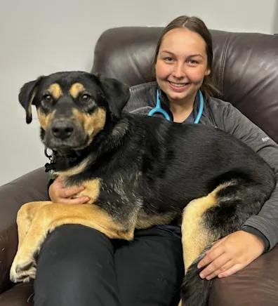 Alyssa kneeling next to a large dog Alyssa kneeling next to a large dog
