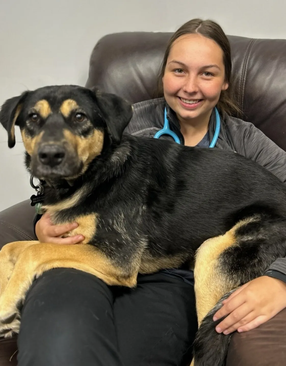 Alyssa kneeling next to a large dog Alyssa kneeling next to a large dog