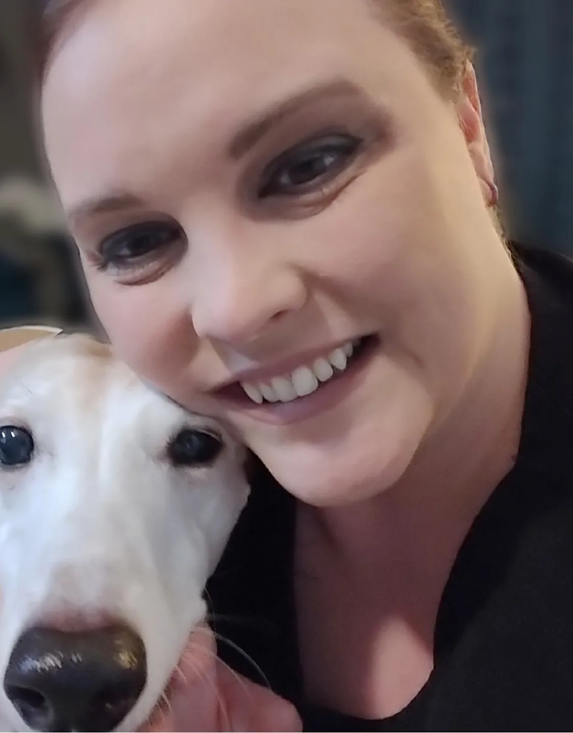 Jennifer smiling, hugging a large white dog Jennifer smiling, hugging a large white dog