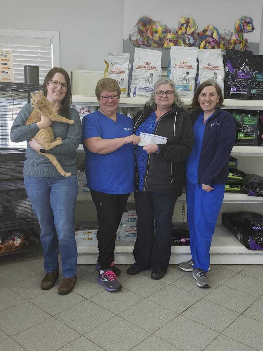 Staff members in front of food bags