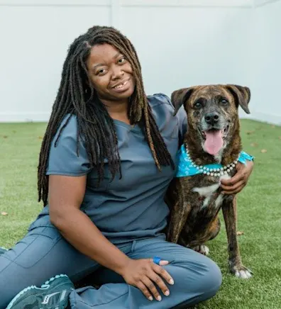 Robin Robinson with brown dog wearing blue bandana Robin Robinson with brown dog wearing blue bandana