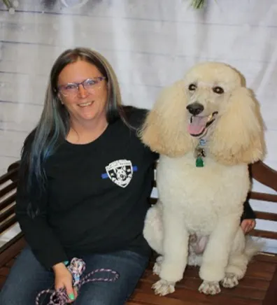 North Branch Staff Member, Dawn, sitting with her white poodle