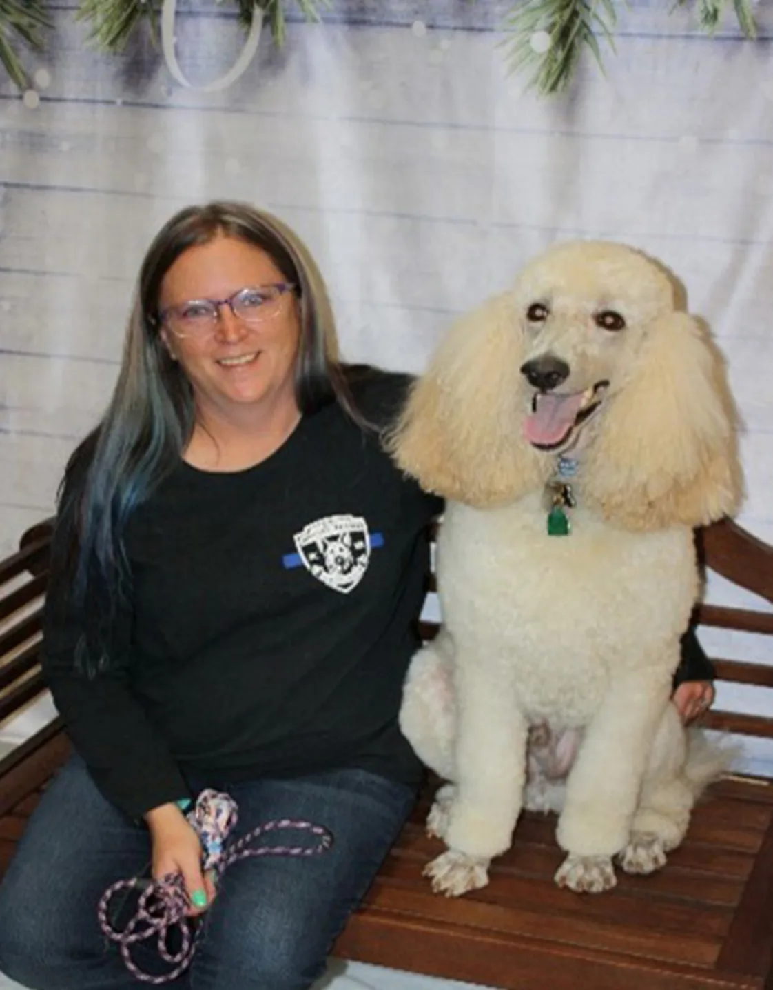 North Branch Staff Member, Dawn, sitting with her white poodle North Branch Staff Member, Dawn, sitting with her white poodle