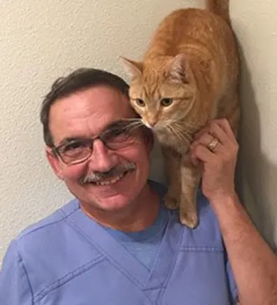 Doug with an orange cat standing on his shoulder Doug with an orange cat standing on his shoulder