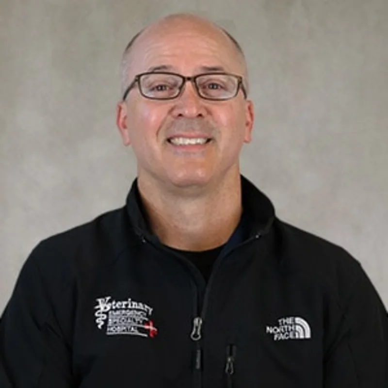 Dr. Mark Schlatter smiling in front of a grey backdrop Dr. Mark Schlatter smiling in front of a grey backdrop