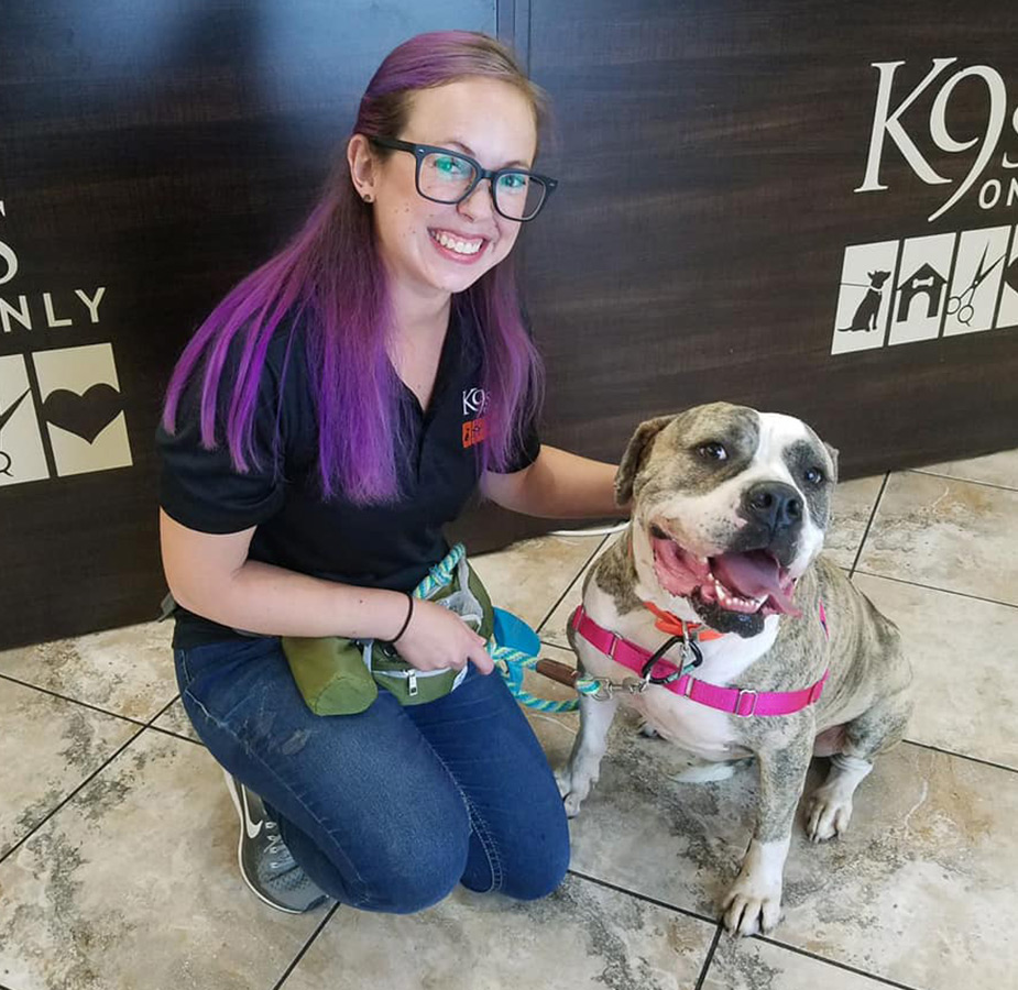 Staff kneeling with dog