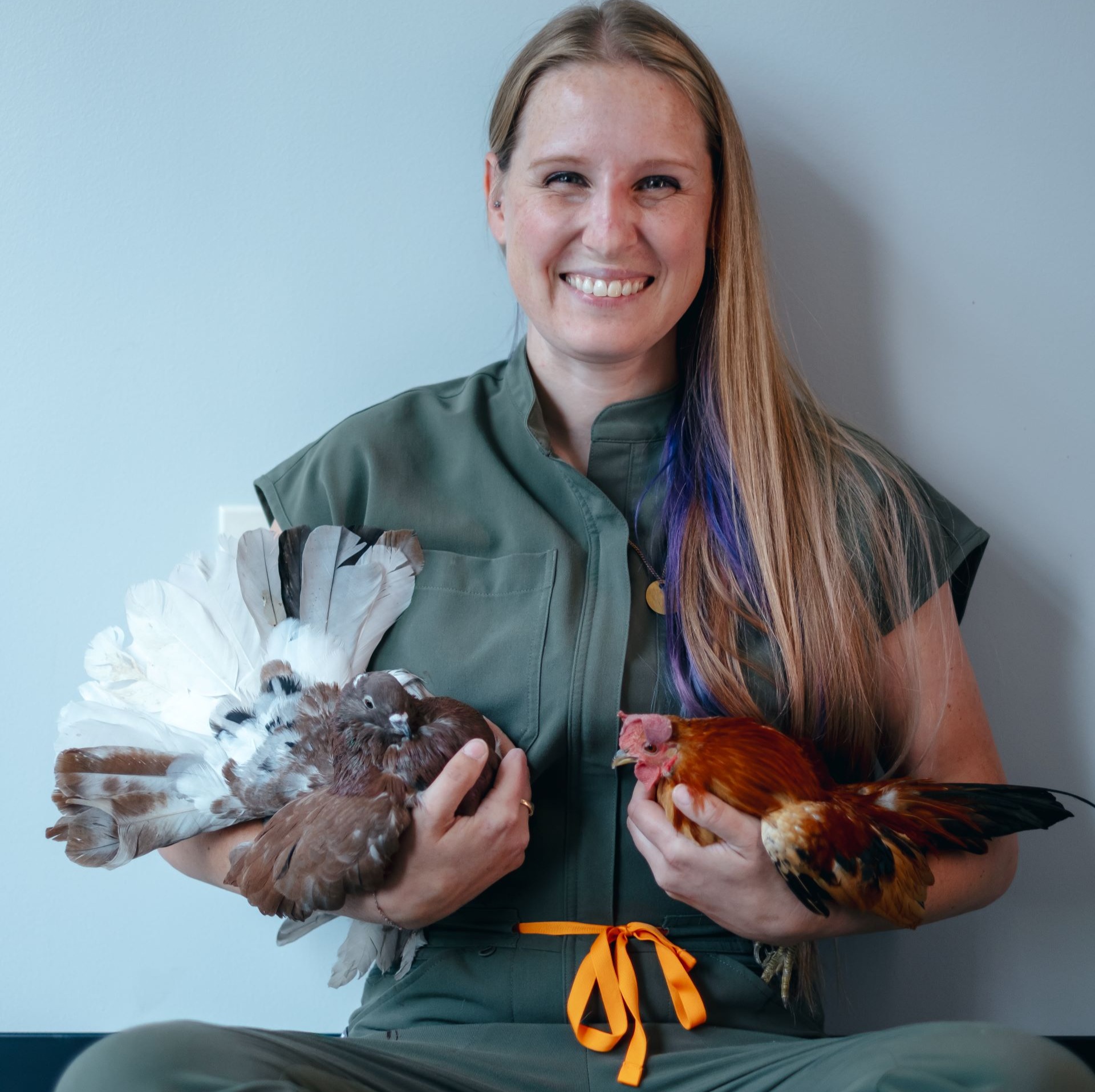 A technician posing with a dog 