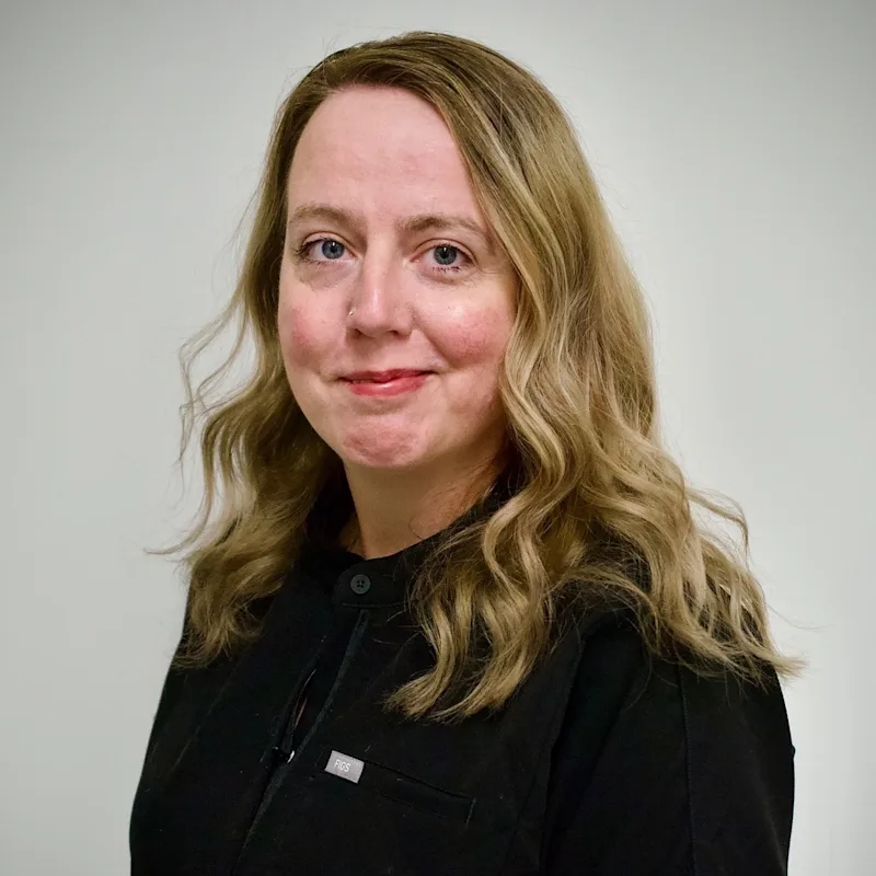 Holly Norris headshot, smiling in a black shirt Holly Norris headshot, smiling in a black shirt