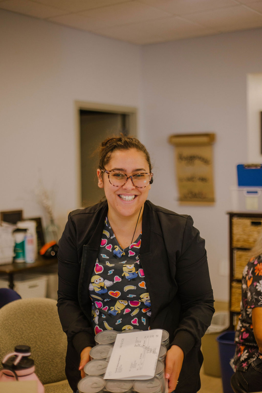 Woman in glasses smiling.