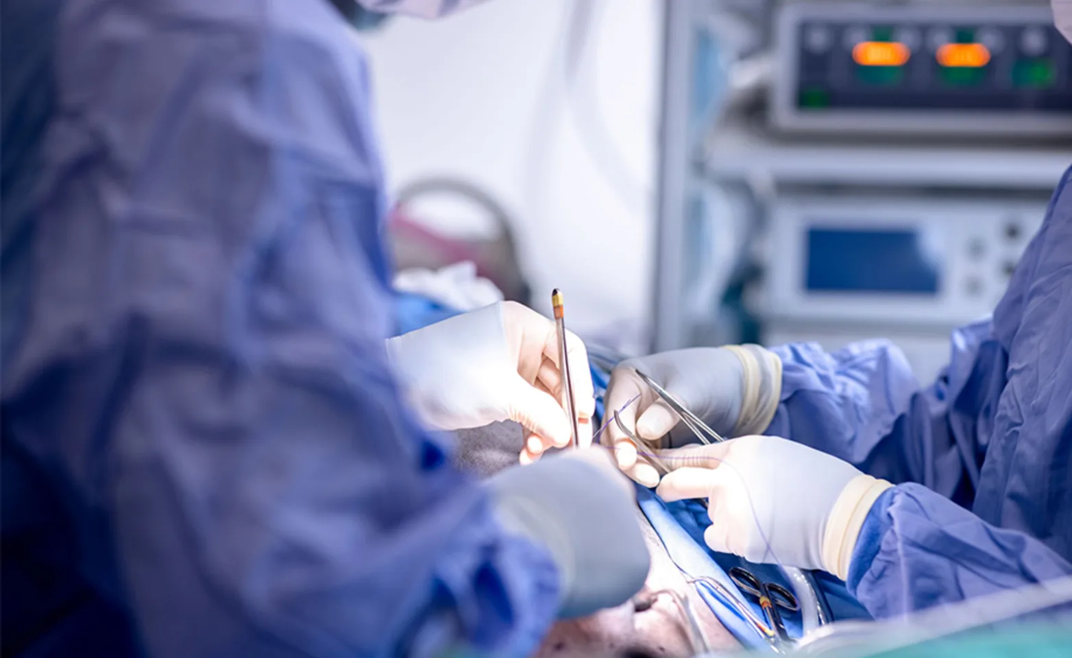 Two vet performing surgery at MissionVet Two vet performing surgery at MissionVet