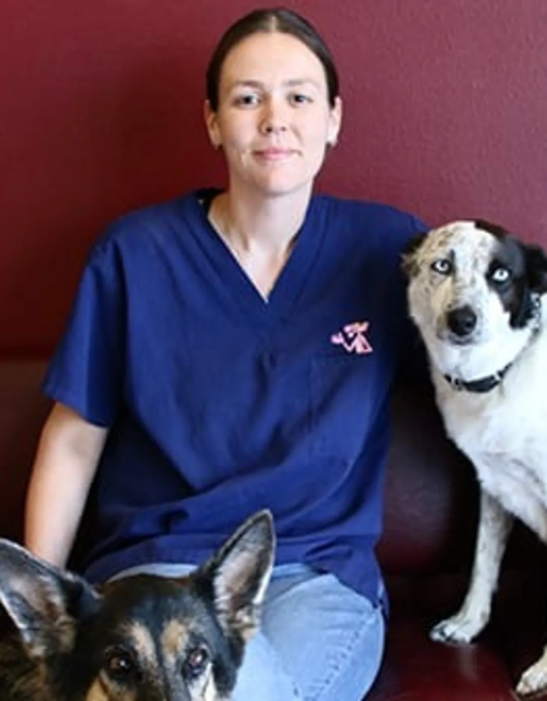 Jessica "JJ" smiling while holding two dogs Jessica "JJ" smiling while holding two dogs