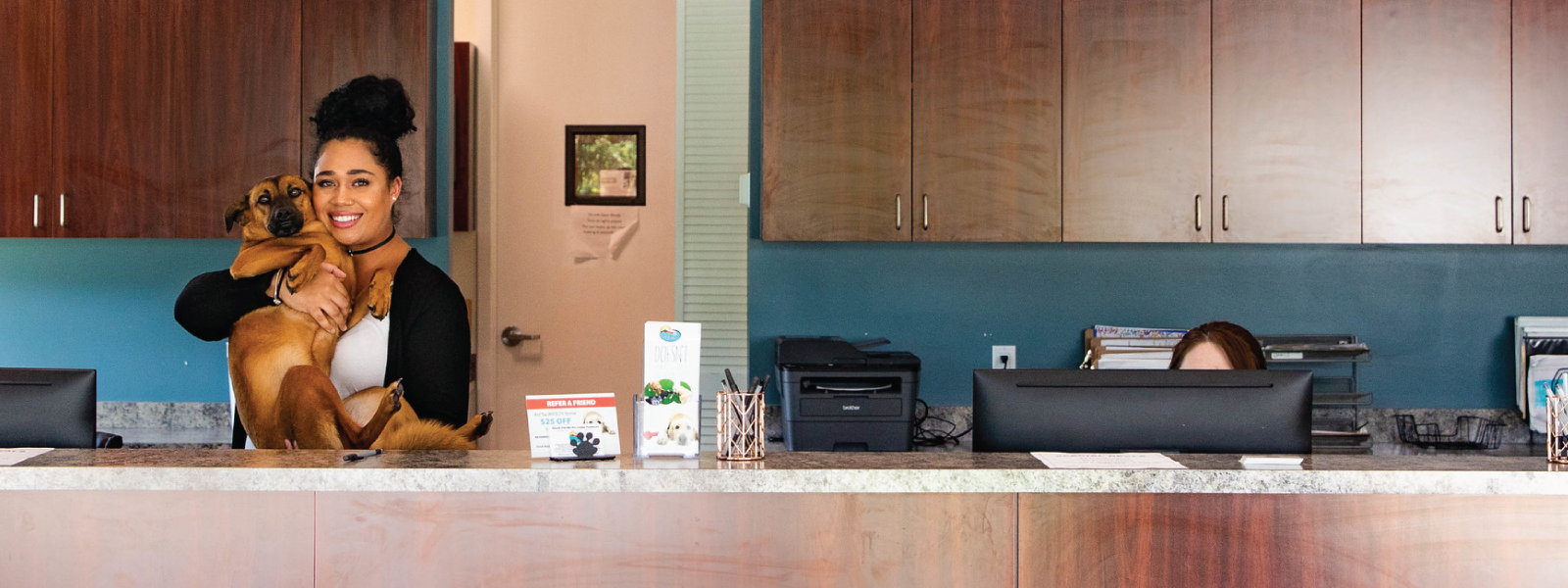 Receptionist and Dog at Desk