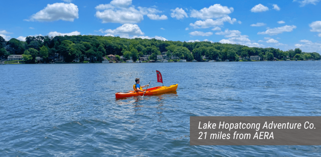 An image of the Lake Hopatcong Adventure Co. with text stating "Lake Hopatcong Adventure Co. 21 miles from AERA".