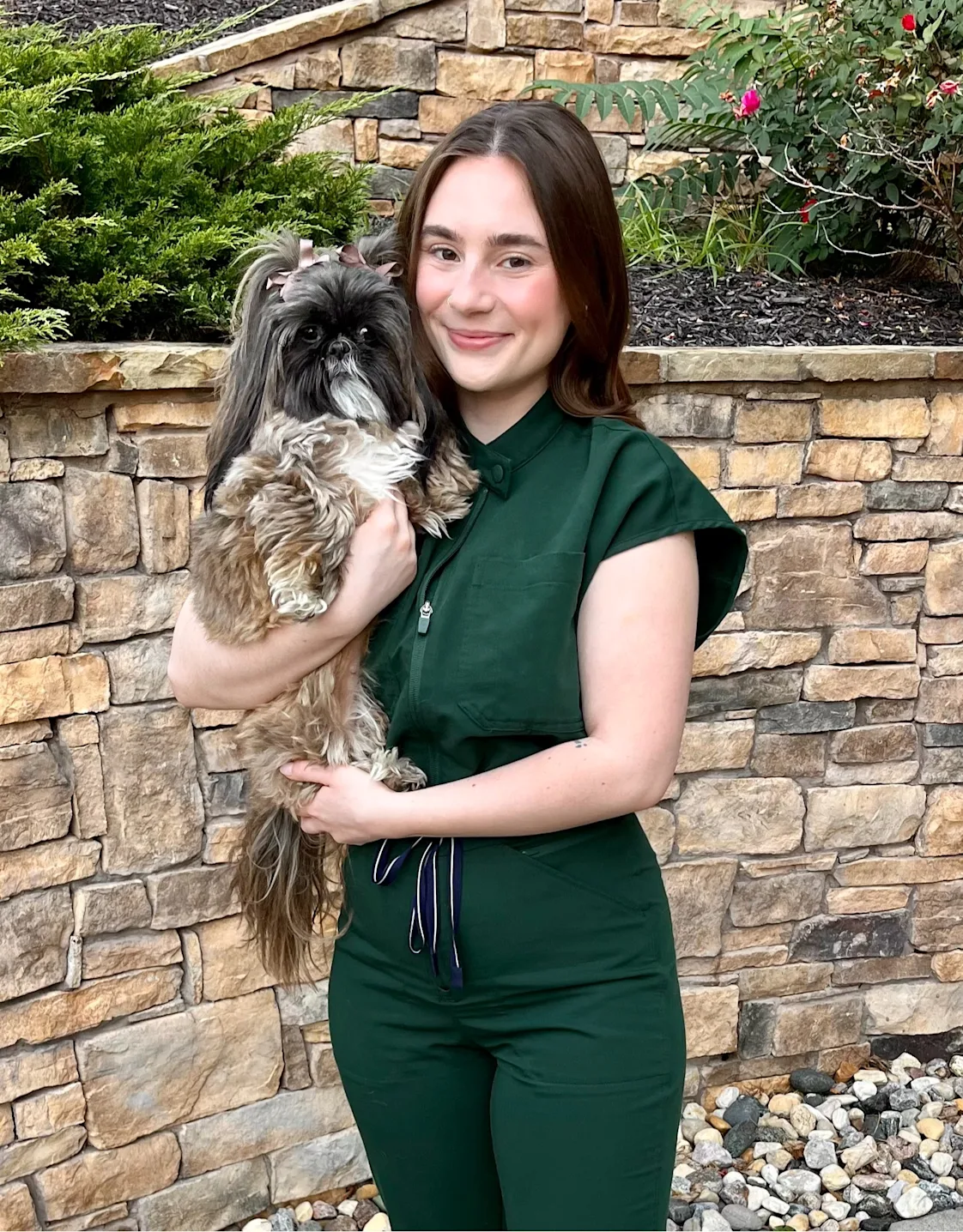 A veterinarian posing with a dog A veterinarian posing with a dog