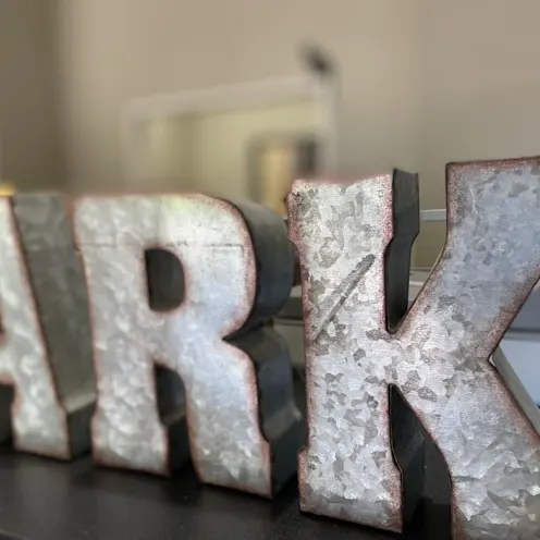 A, R, K letters in metal form. A, R, K letters in metal form.