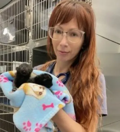 Richelle holding a kitten in a blue blanket Richelle holding a kitten in a blue blanket