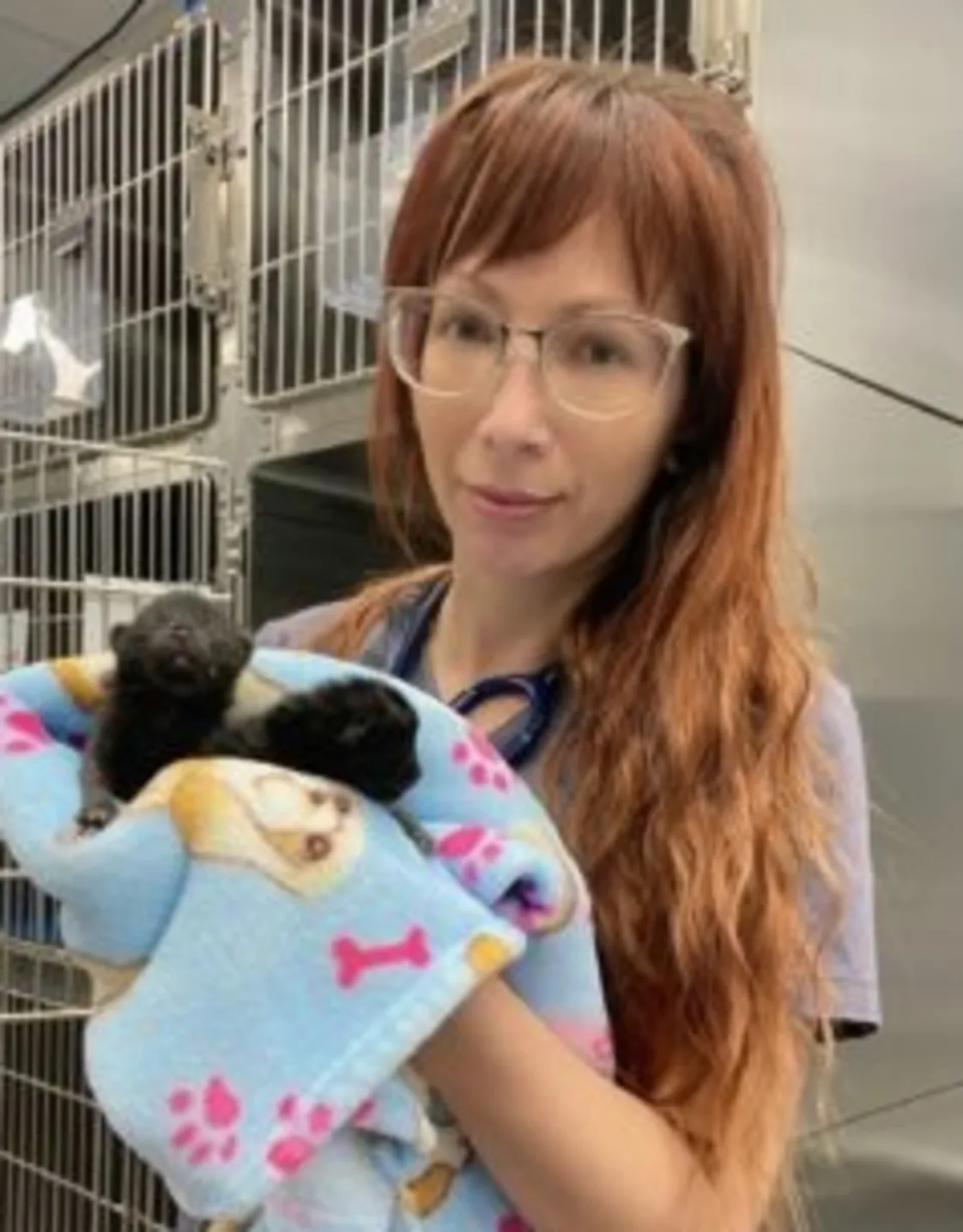 Richelle holding a kitten in a blue blanket Richelle holding a kitten in a blue blanket