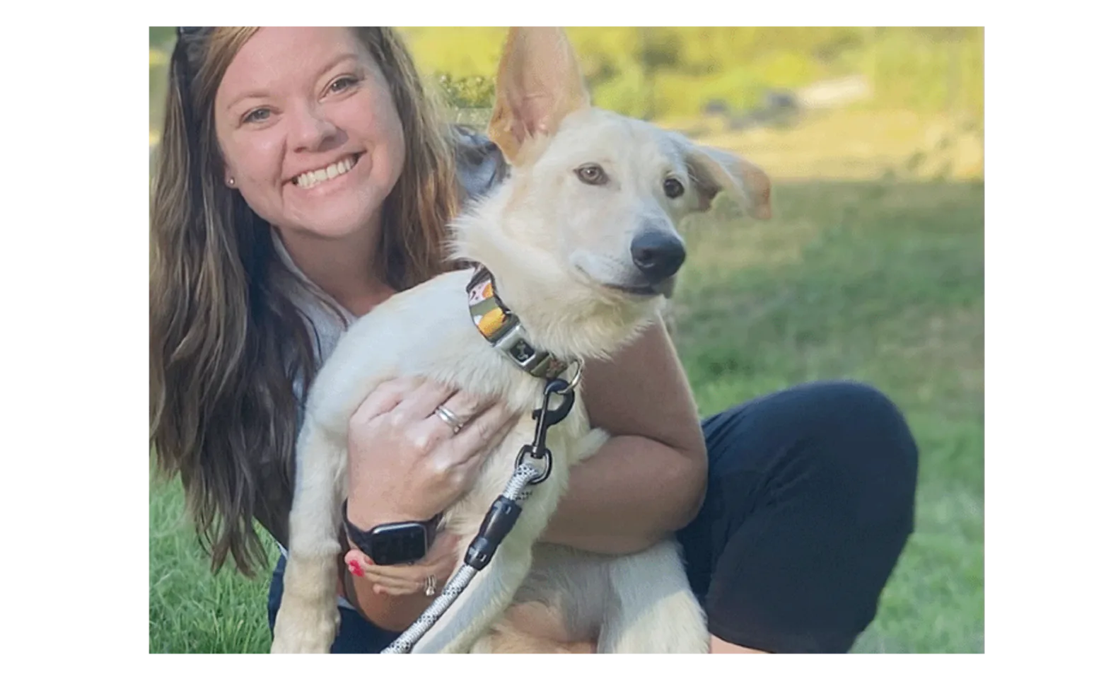 Social Worker Colleen Tata hugging a dog