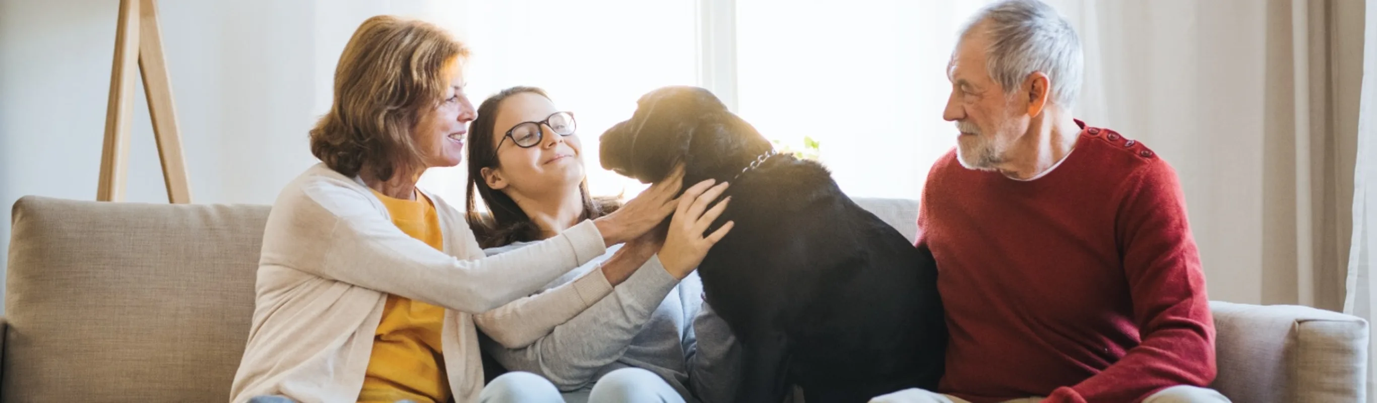 Family on couch with dog