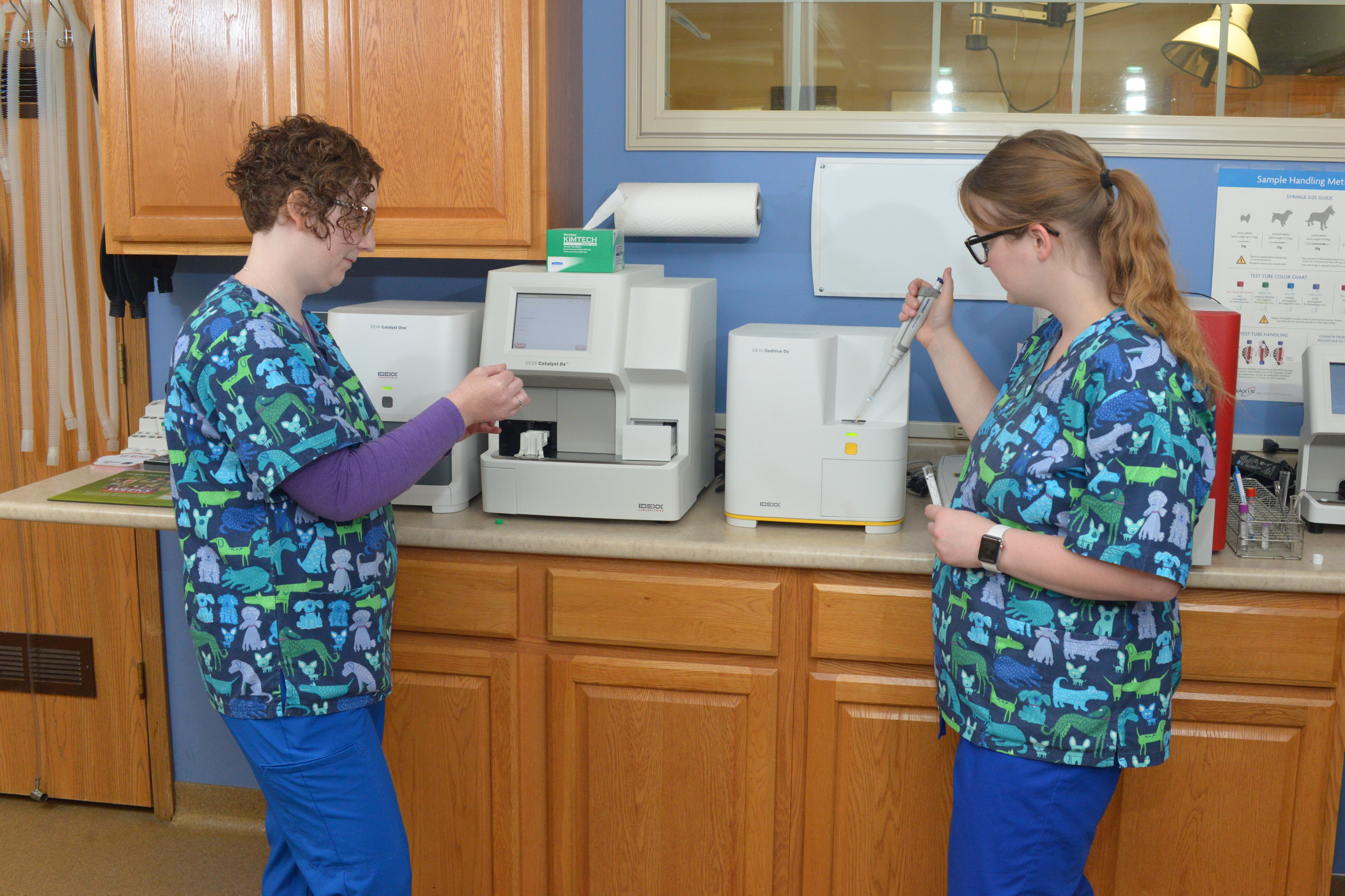 Two Veterinary staff in front of medical equipment
