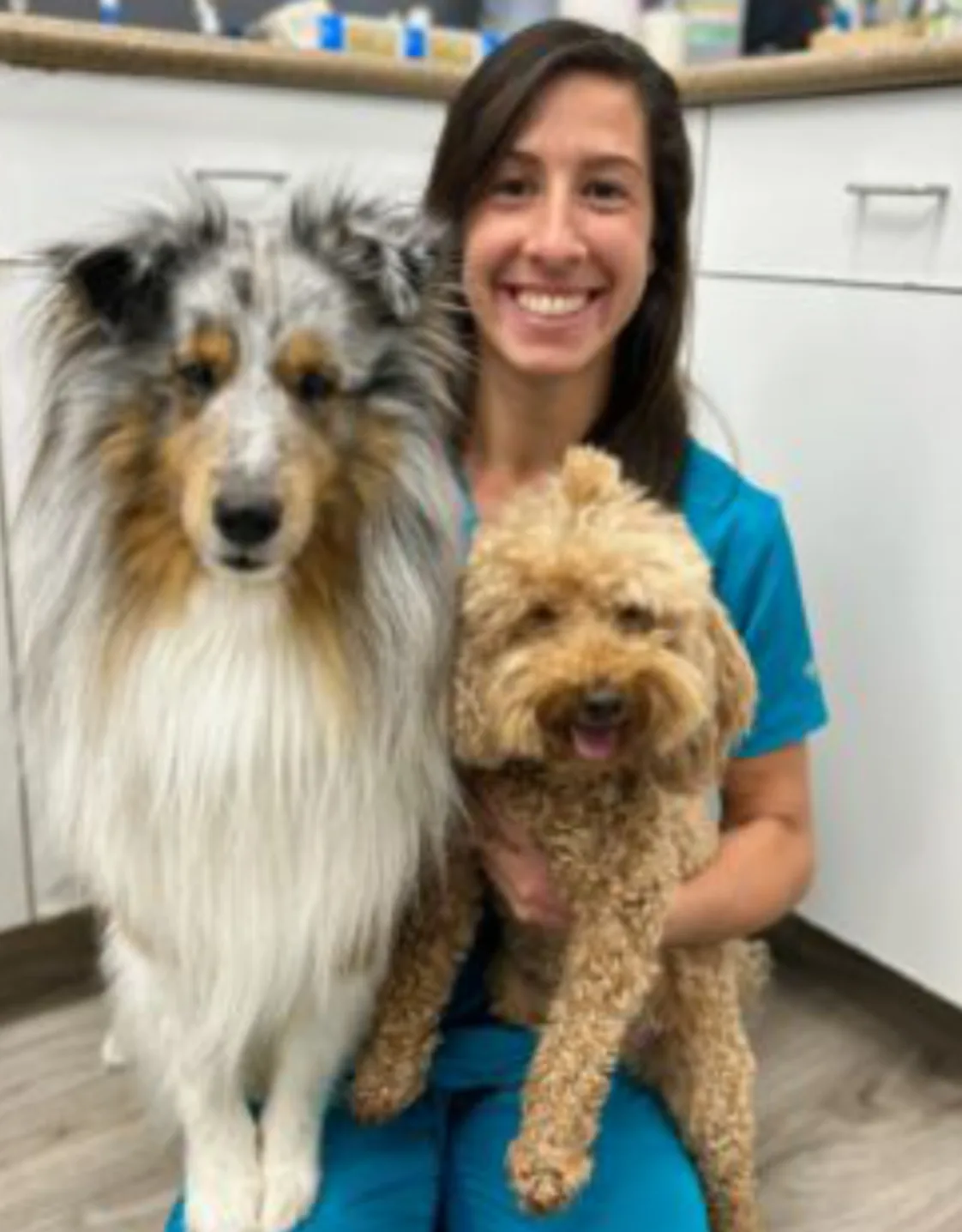 Dr. Maite Taam holding two dogs Dr. Maite Taam holding two dogs