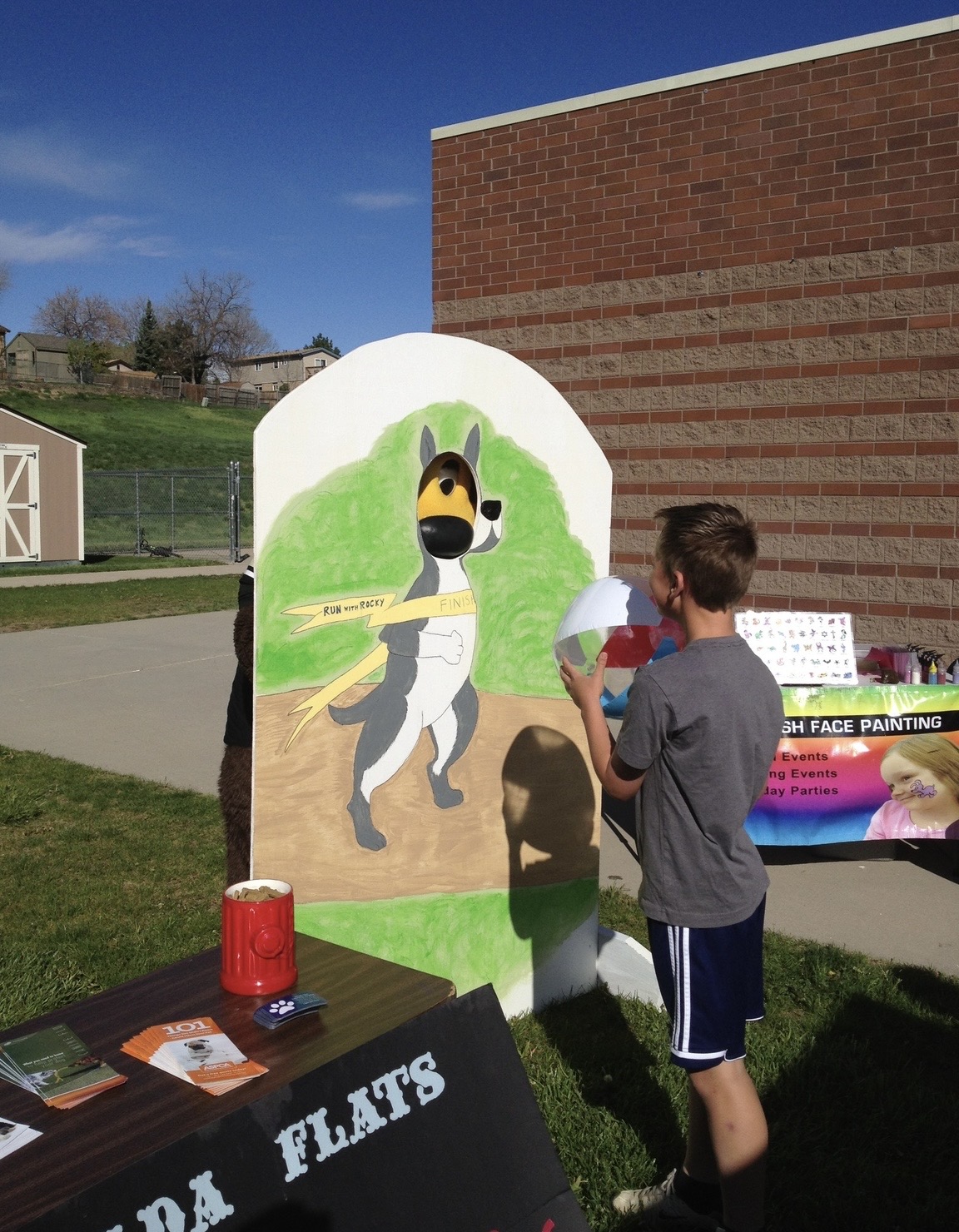 An event attendee standing in front of a cut out