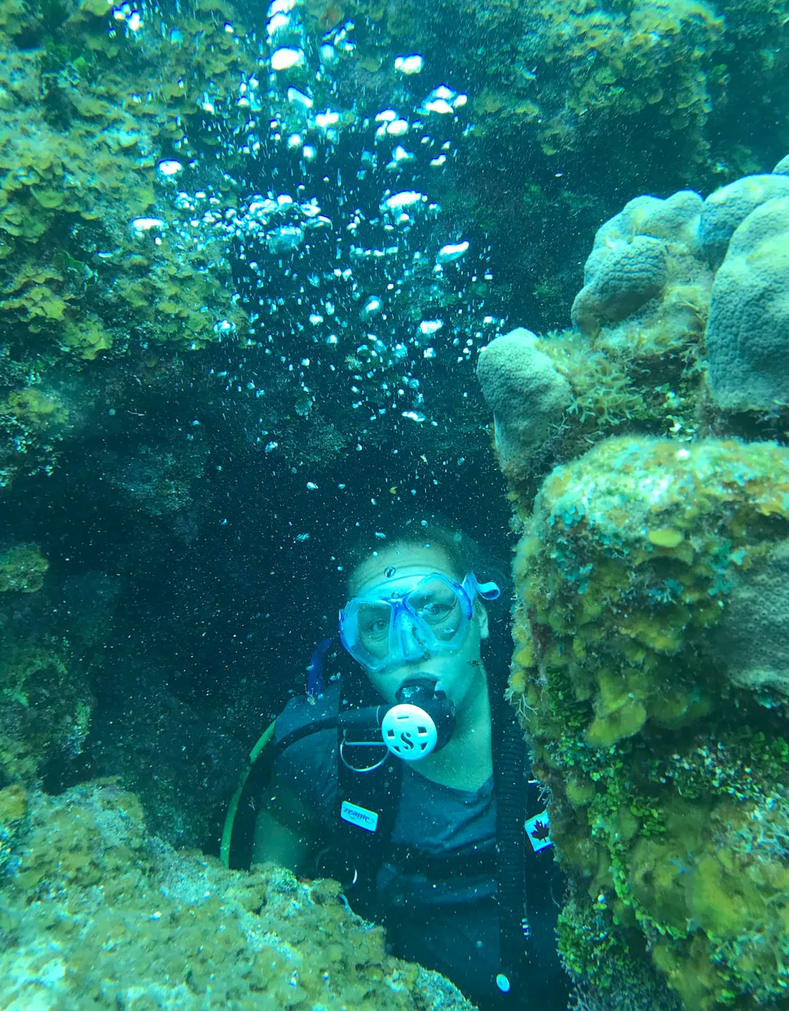Kristen Roberts diving between corals Kristen Roberts diving between corals