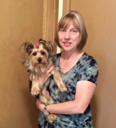 Jill Meunier posing with a Yorkie