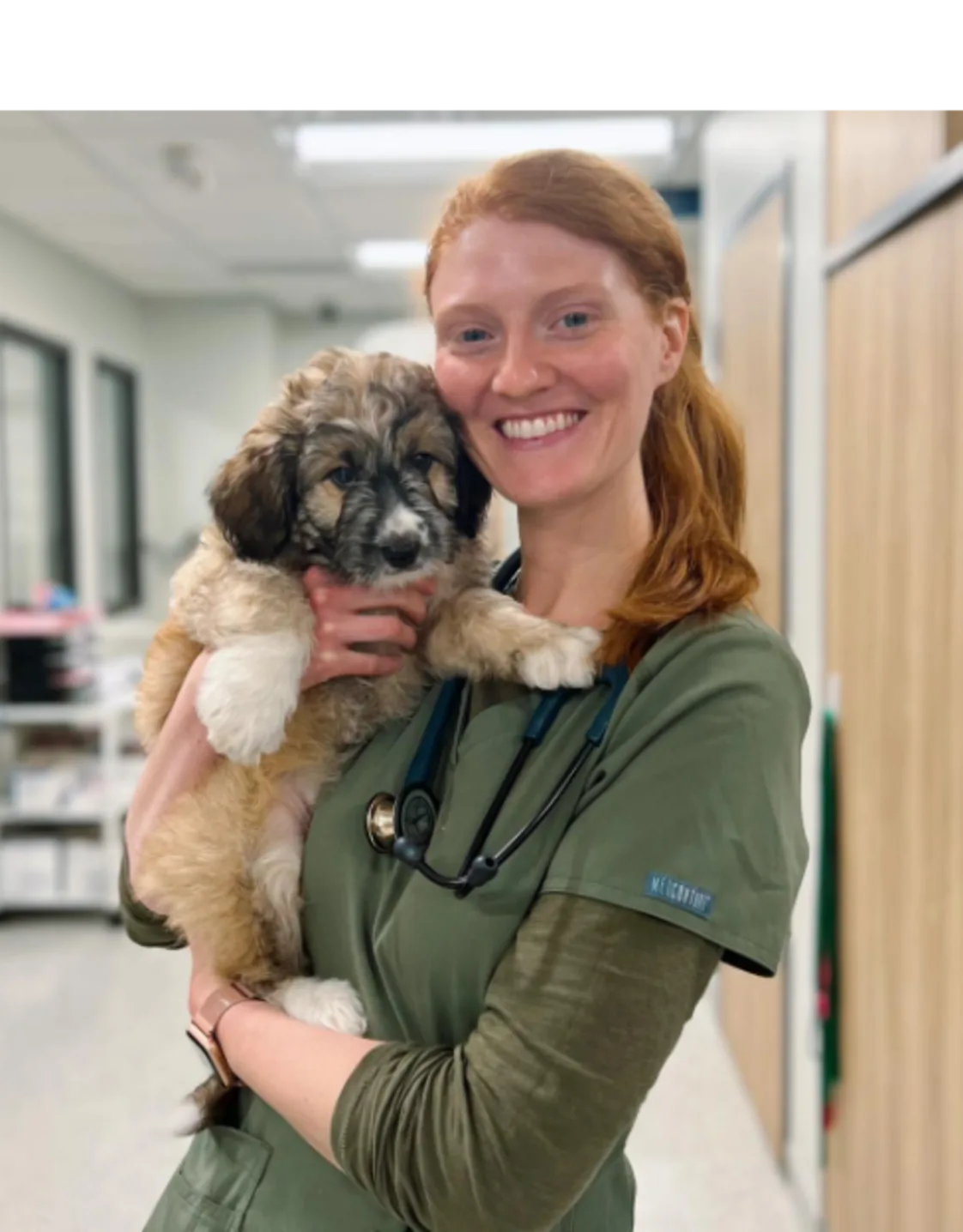 A veterinarian posing with a dog A veterinarian posing with a dog