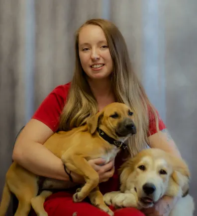 Paige sitting next to three dogs