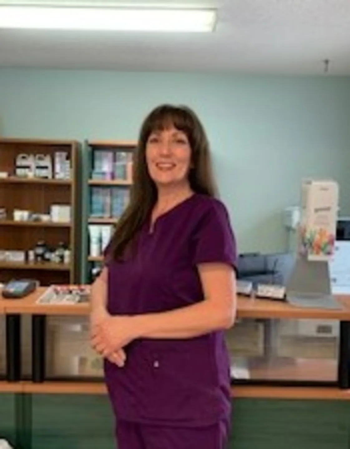 Kim of Three Islands Veterinary Clinic standing in the front office of the hospital Kim of Three Islands Veterinary Clinic standing in the front office of the hospital