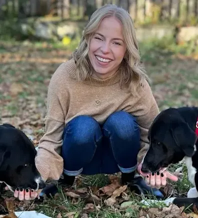 Calle smiling with two black dogs. Calle smiling with two black dogs.