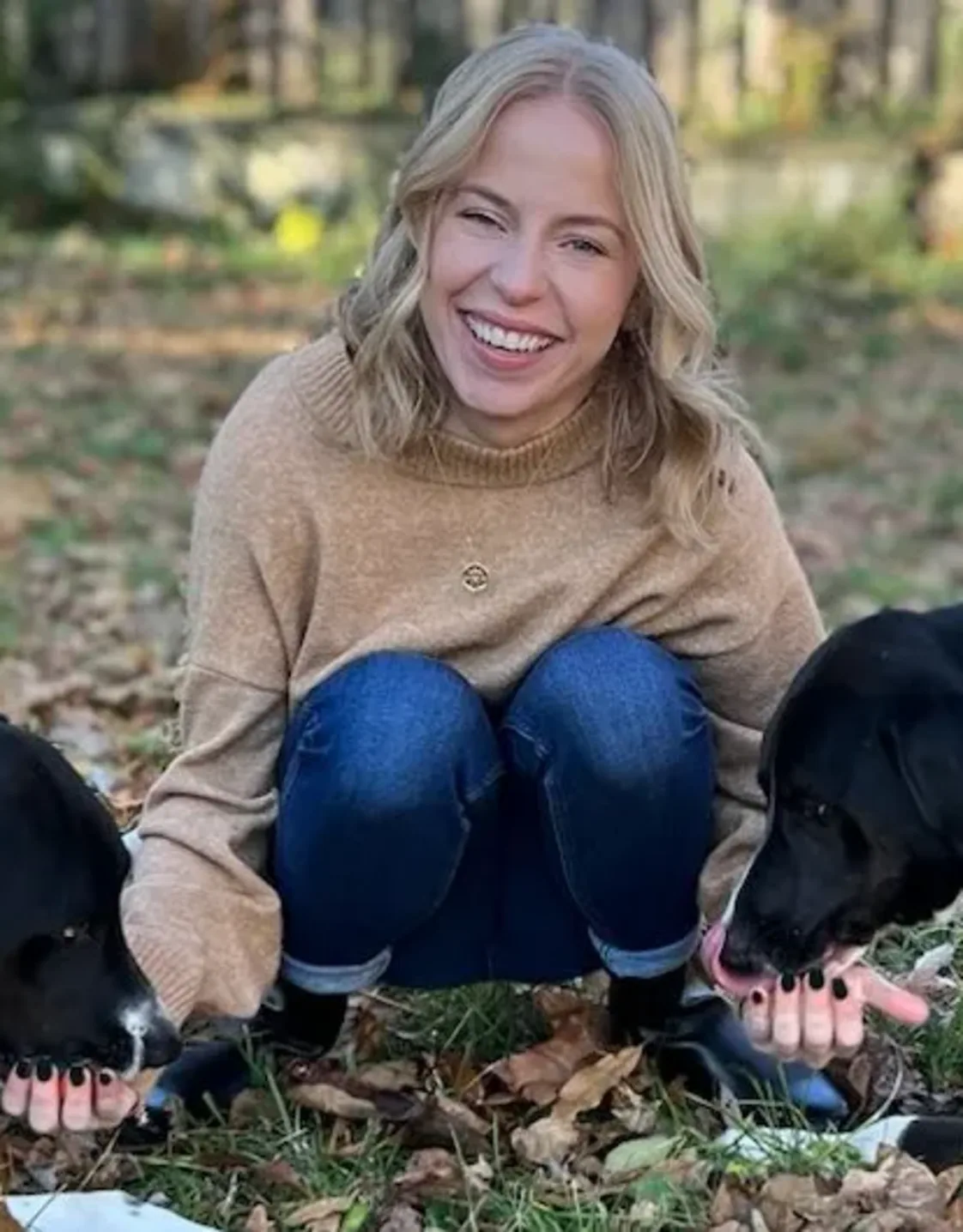 Calle smiling with two black dogs. Calle smiling with two black dogs.