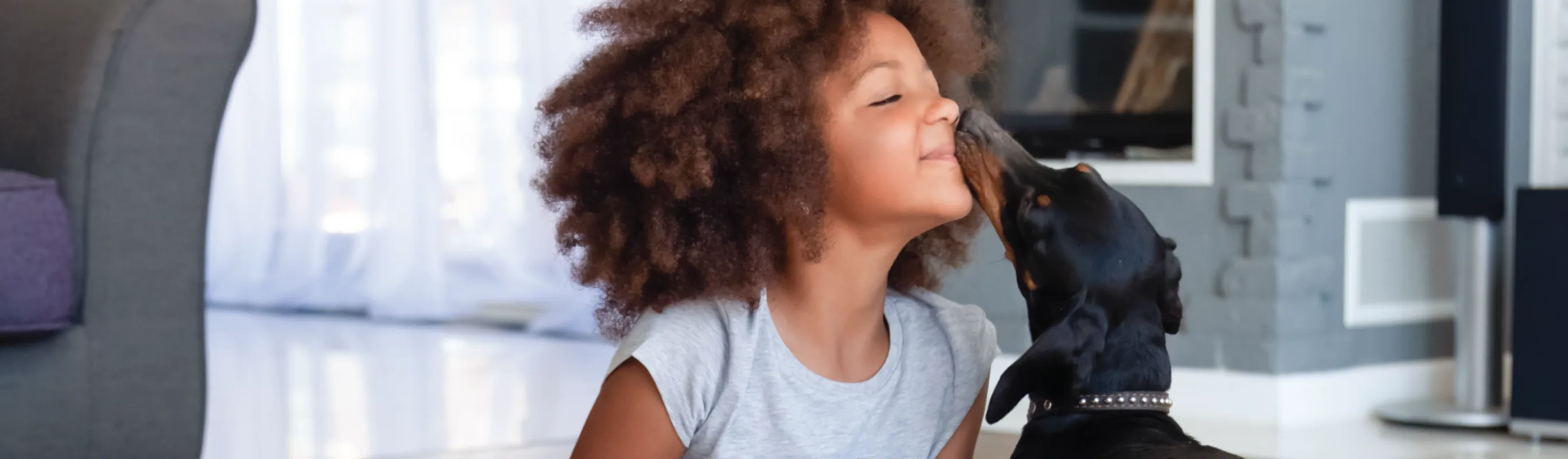 Dog licking kid's nose