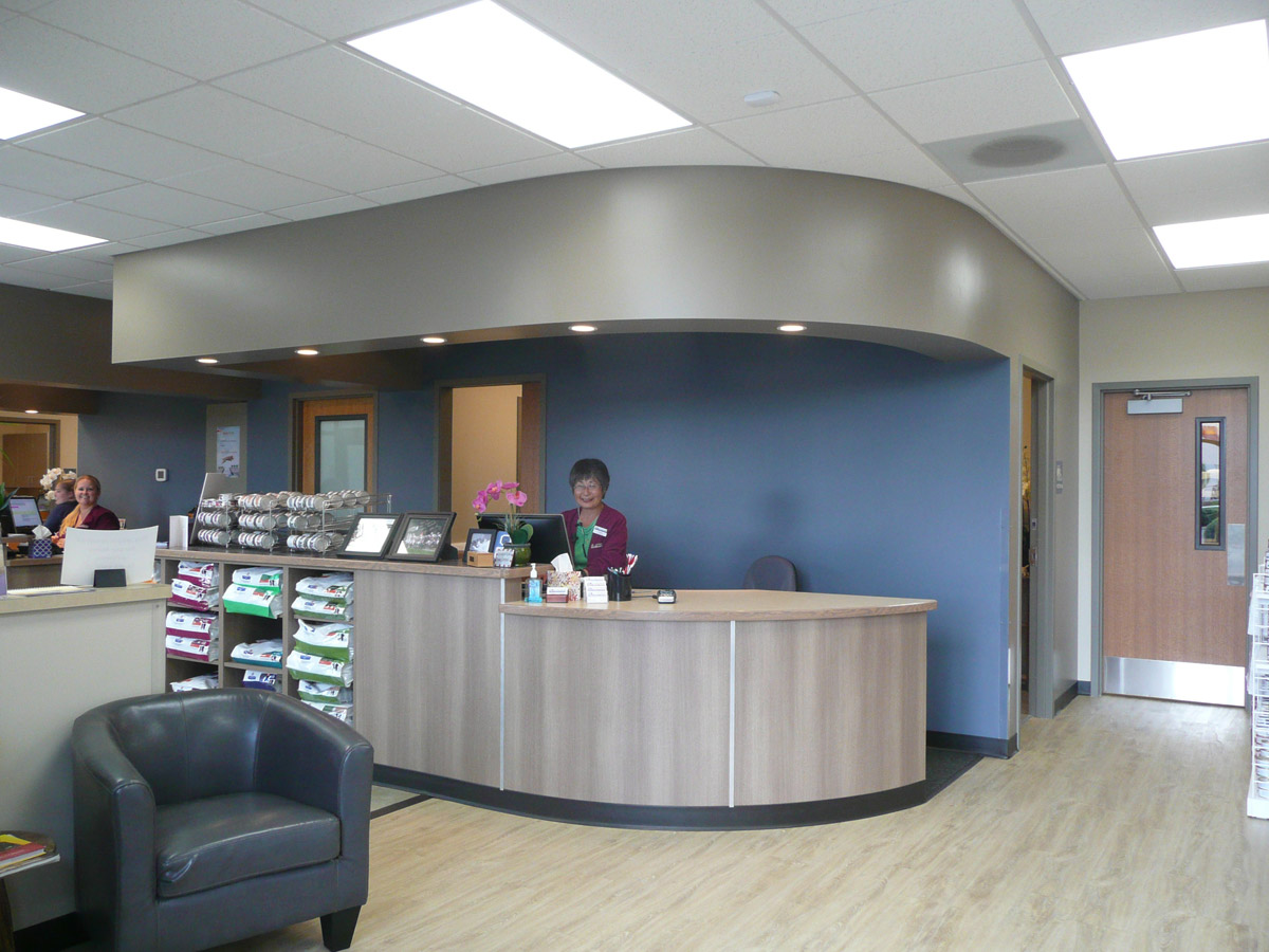a staff member stands behind a counter in the lobby of SouthCare Animal Medical Center