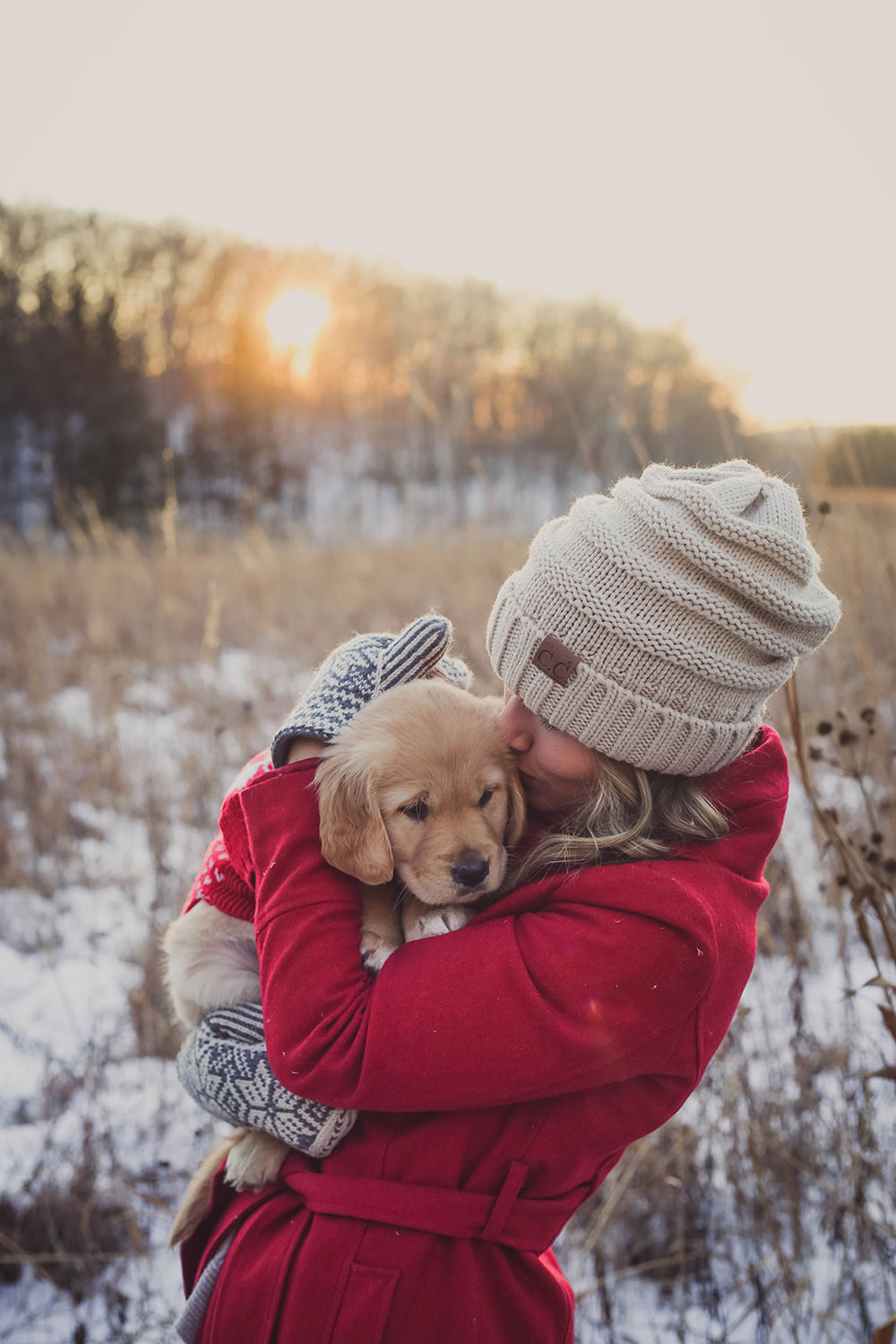 Woman kissing puppy