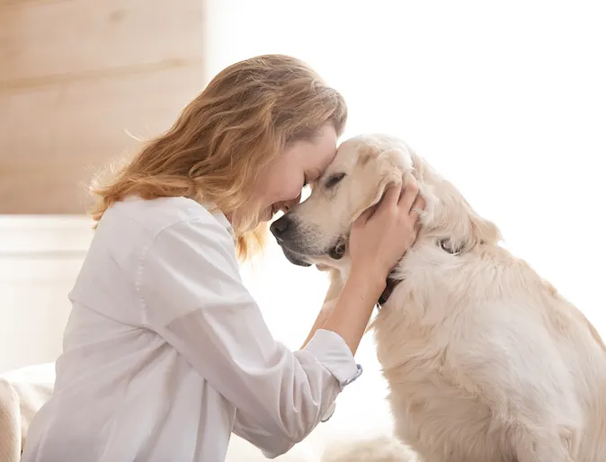 Owner cuddling her dog Owner cuddling her dog