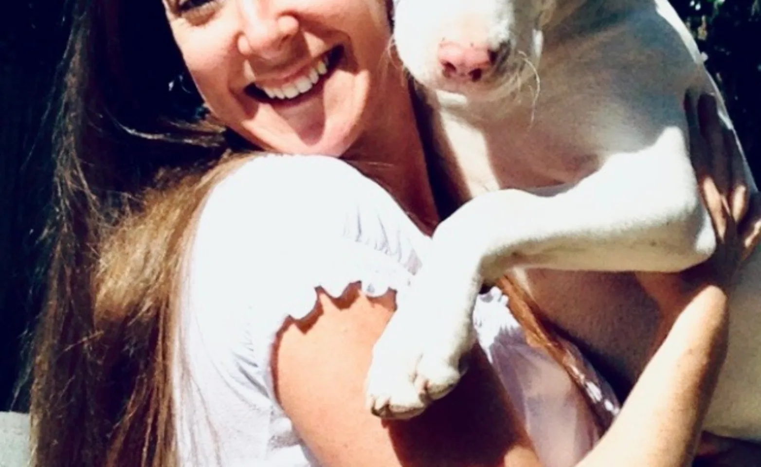 Ellen holding her large white dog. Ellen holding her large white dog.