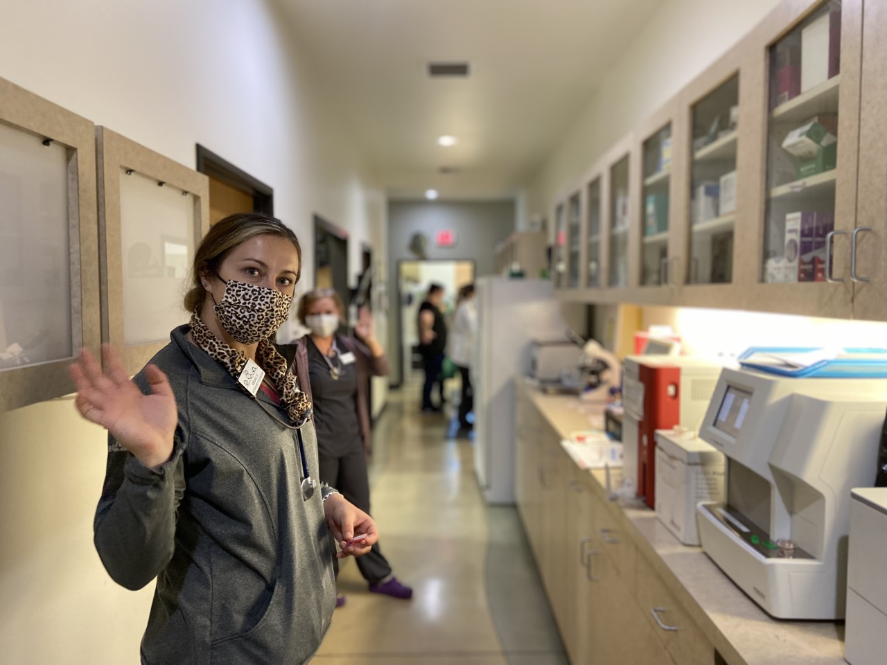 Woman waving at the camera in the hall at The Ark Veterinary Clinic